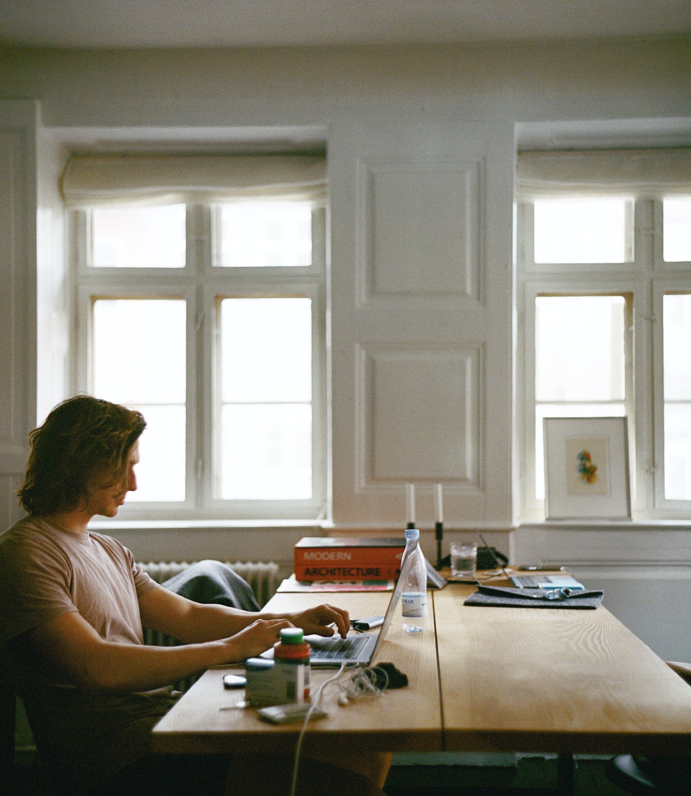 An individual sitting at a table working from home.